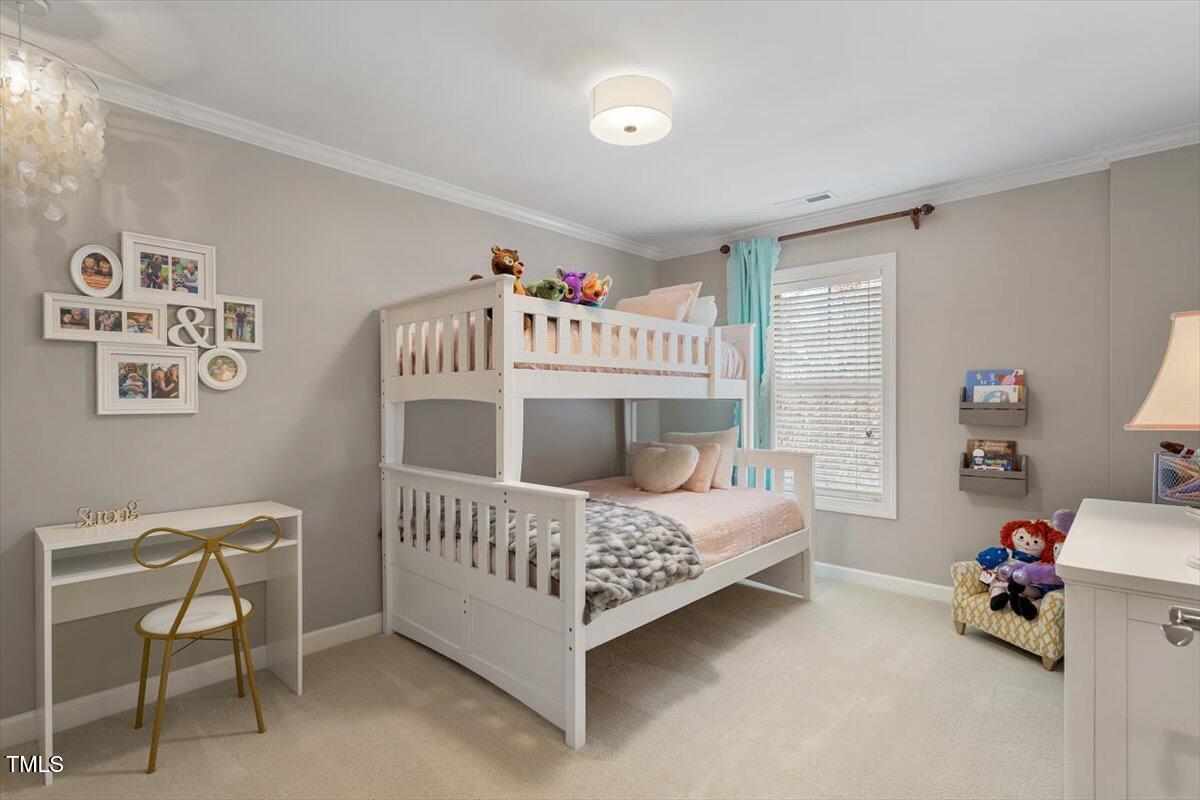 105 Sunstone Drive Cary, NC 27519 - Photo 19 of 25 a bedroom with a bed and a table in it