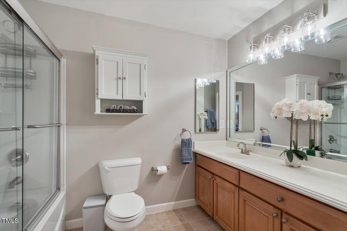 105 Sunstone Drive Cary, NC 27519 - Photo 20 of 25 a bathroom with a toilet sink and mirror