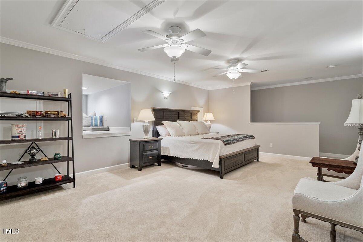 105 Sunstone Drive Cary, NC 27519 - Photo 22 of 25 a spacious bedroom with a bed and a chandelier