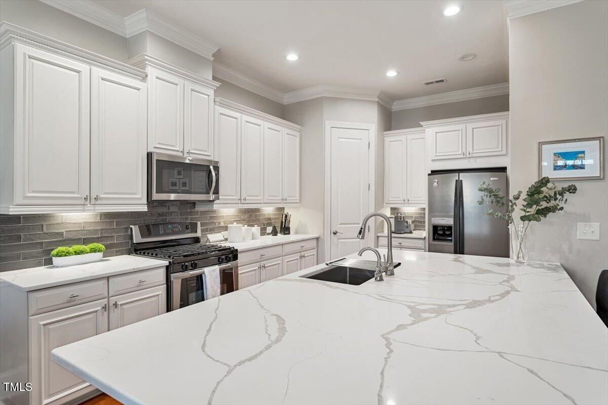 105 Sunstone Drive Cary, NC 27519 - Photo 2 of 25 a kitchen with a sink a stove and cabinets