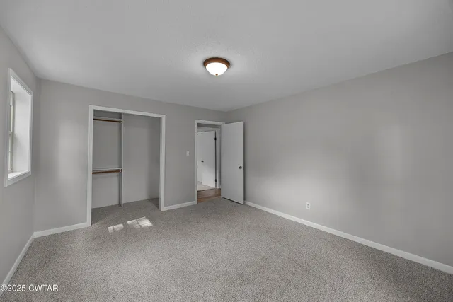 a view of an empty room and a window