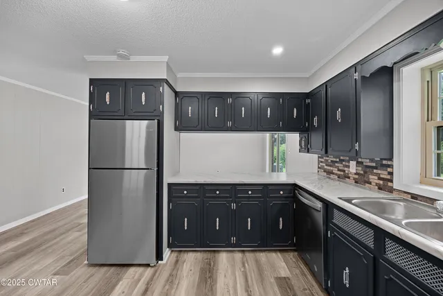 a kitchen with a sink and a refrigerator