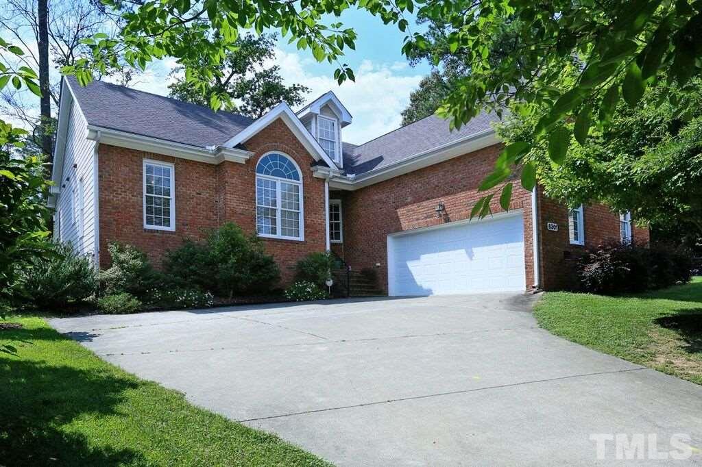 6301 Pleasant Creek Court Raleigh, NC 27613 - Photo 1 of 21 a front view of a house with a yard and a garage