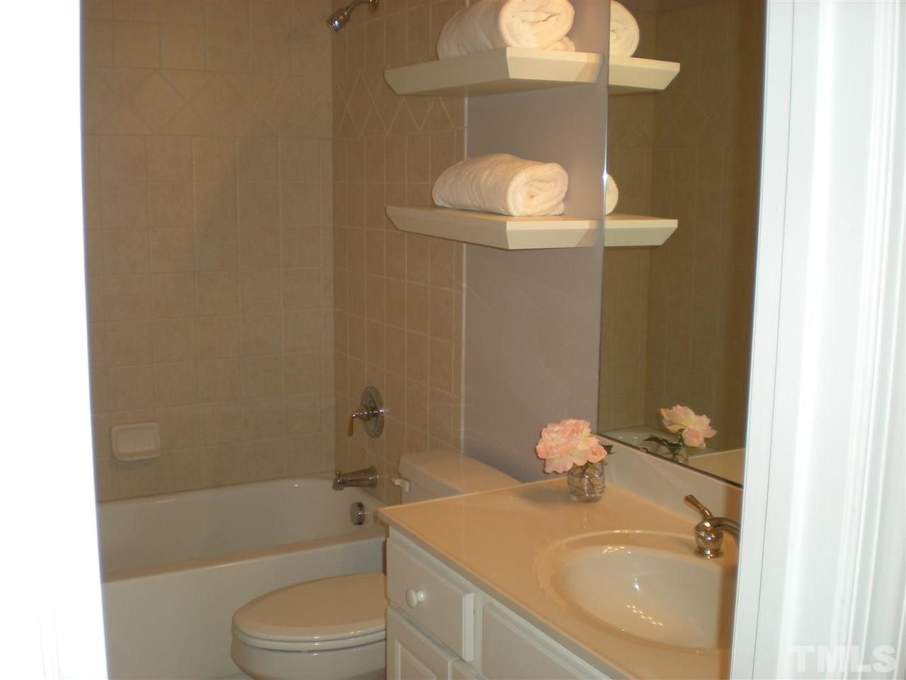 6301 Pleasant Creek Court Raleigh, NC 27613 - Photo 12 of 21 a bathroom with a sink a toilet and shower