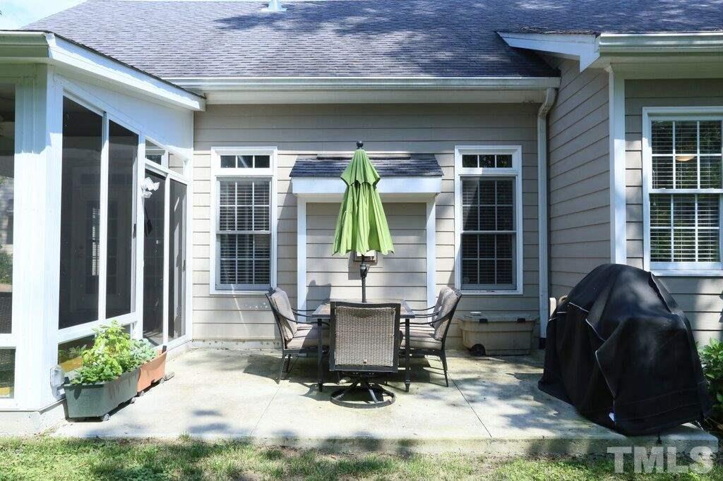 6301 Pleasant Creek Court Raleigh, NC 27613 - Photo 18 of 21 a building outdoor space with patio furniture and potted plants