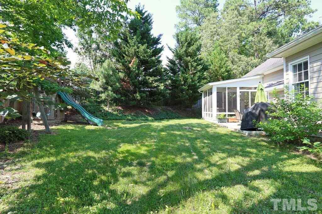 6301 Pleasant Creek Court Raleigh, NC 27613 - Photo 20 of 21 a view of a house with backyard and a tree