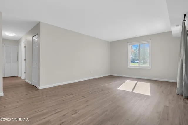 a living room with furniture large window and a flat screen tv