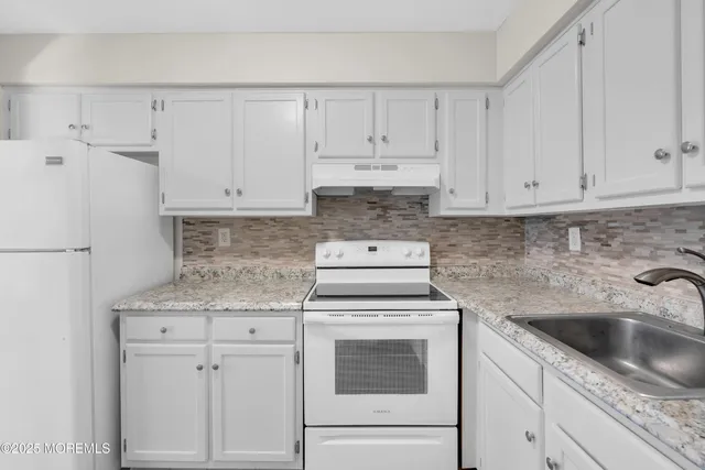 a bedroom with a bed a couch and dresser