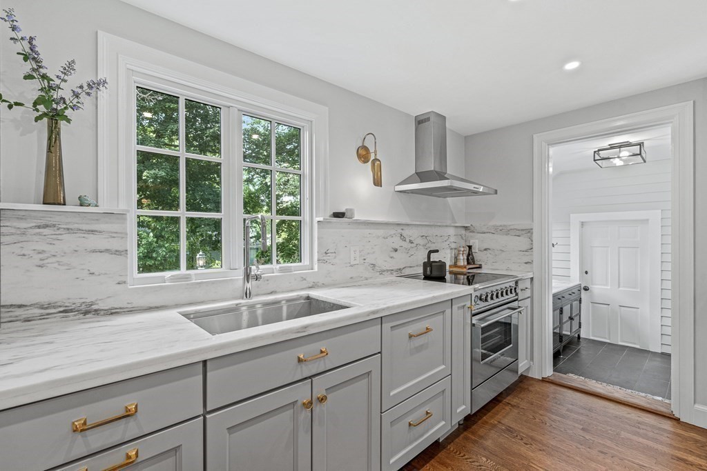 49 Ripley Road Medford, MA 02155 - Photo 11 of 39 a kitchen with stainless steel appliances a sink stove and cabinets