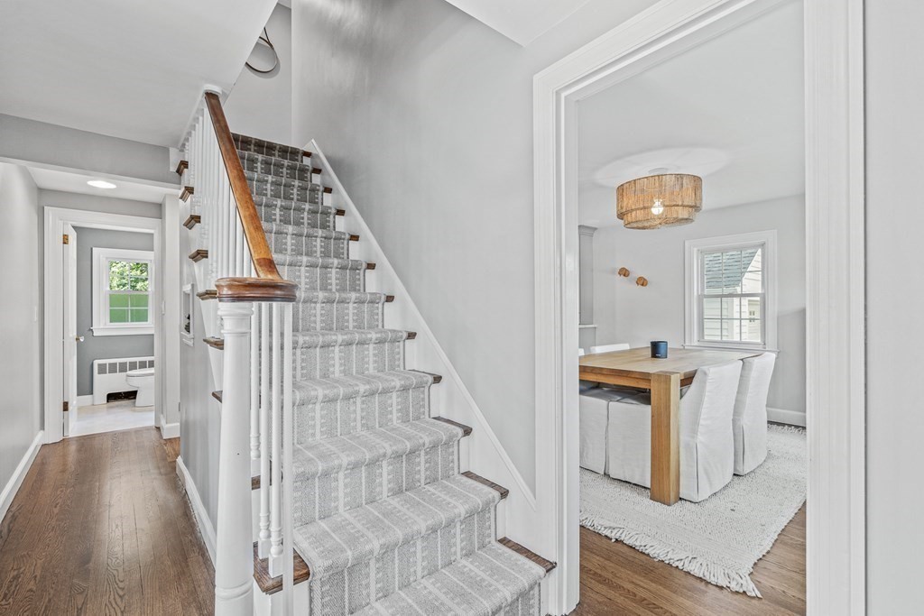 49 Ripley Road Medford, MA 02155 - Photo 16 of 39 a view of a hallway with wooden floor and staircase