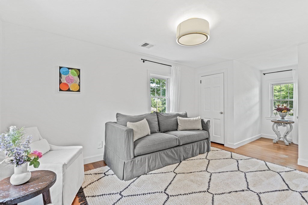 49 Ripley Road Medford, MA 02155 - Photo 19 of 39 a living room with furniture and a dining table