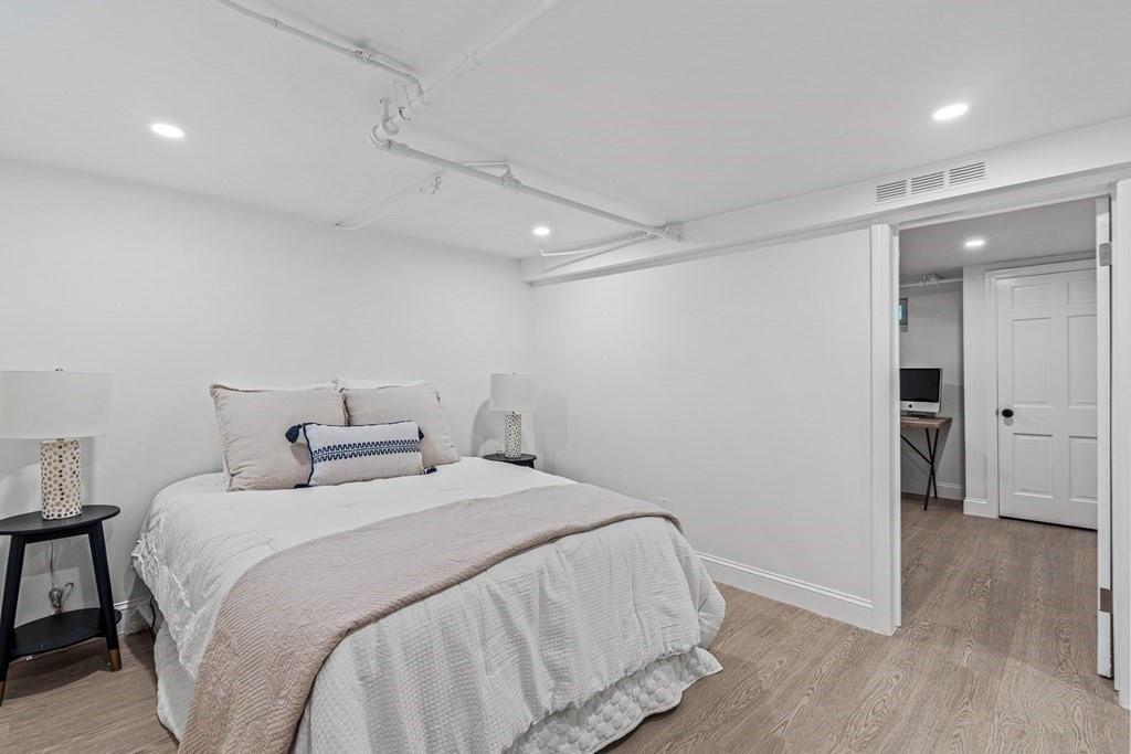 49 Ripley Road Medford, MA 02155 - Photo 24 of 39 a bedroom with a bed and a refrigerator