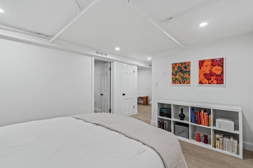 49 Ripley Road Medford, MA 02155 - Photo 26 of 39 a bedroom with a bed and a book shelf