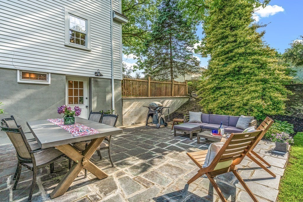 49 Ripley Road Medford, MA 02155 - Photo 30 of 39 a view of a patio with table and chairs and potted plants
