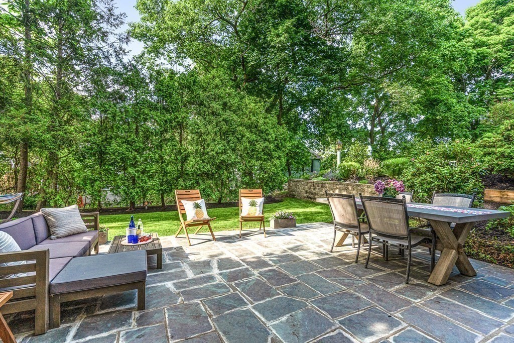49 Ripley Road Medford, MA 02155 - Photo 3 of 39 a view of a patio with a dining table and chairs with a small yard