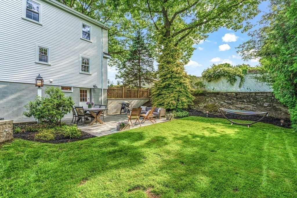 49 Ripley Road Medford, MA 02155 - Photo 34 of 39 a view of backyard of house with outdoor seating and green space