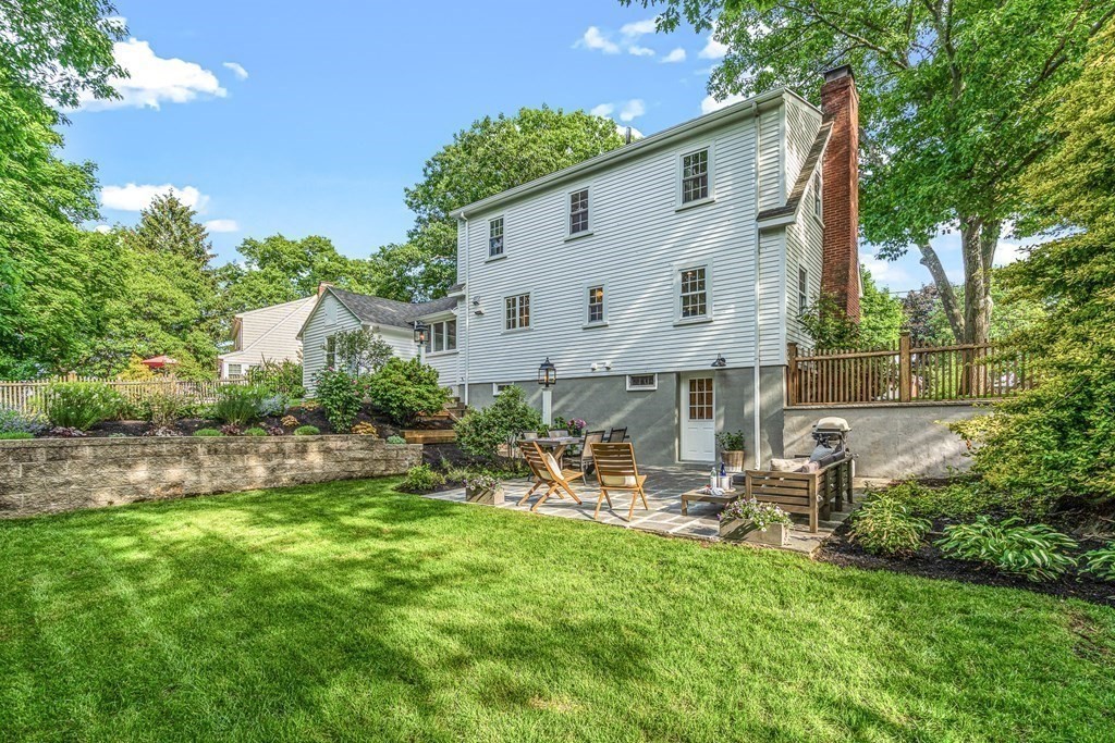 49 Ripley Road Medford, MA 02155 - Photo 35 of 39 a view of a white house with a yard and sitting area