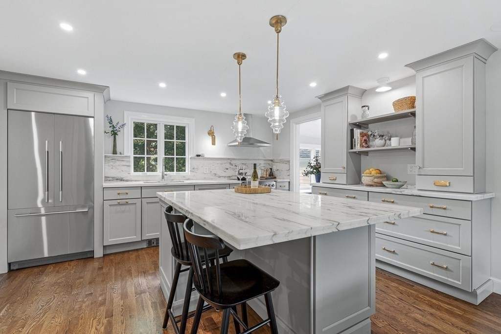 49 Ripley Road Medford, MA 02155 - Photo 8 of 39 a kitchen with kitchen island white cabinets and stainless steel appliances
