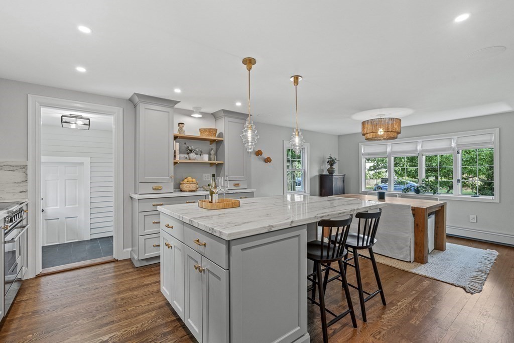 49 Ripley Road Medford, MA 02155 - Photo 10 of 39 a kitchen with a table chairs refrigerator and cabinets