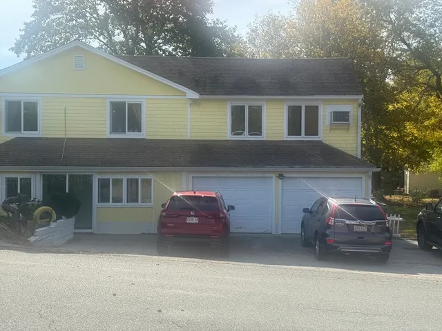 a couple of cars parked in front of a house