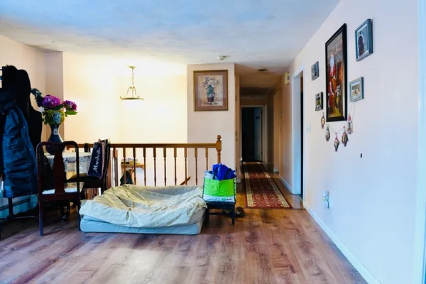 a view of a bedroom with furniture and wooden floor