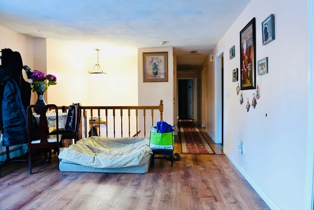 a view of a bedroom with furniture and wooden floor