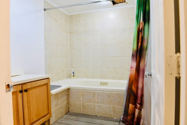 a bathroom with a bathtub and a shower