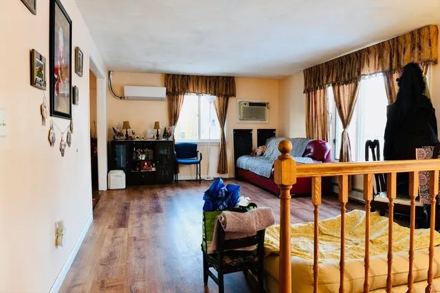 a living room with furniture fireplace and a large window