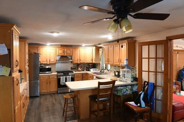 a view of a dining room with furniture a chandelier and wooden floor