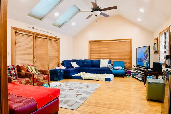 a bedroom with furniture and a flat screen tv