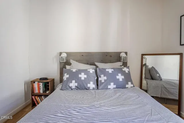 a bedroom with a bed and a window