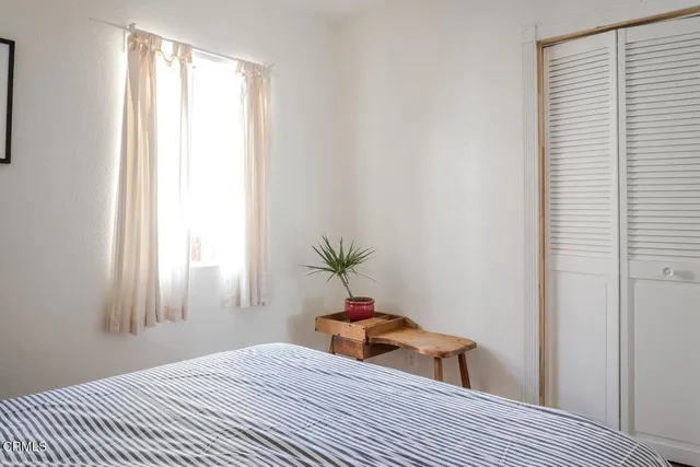 a view of a room with wooden floor and bench in a room