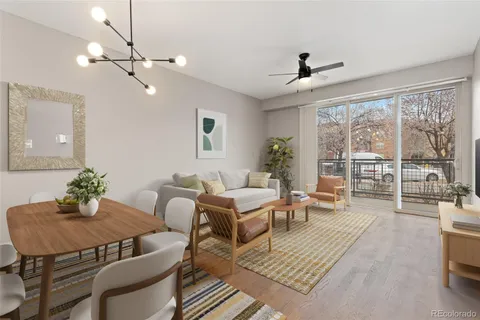 a living room with furniture wooden floor and a chandelier