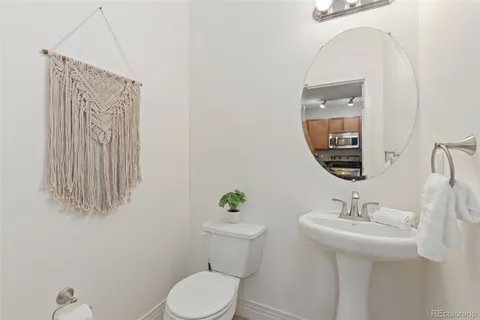 a bathroom with a sink a toilet and mirror