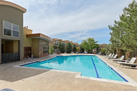 a view of a swimming pool with an outdoor seating