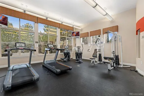 a view of a gym with gym equipment