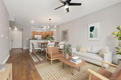 a living room with furniture and a chandelier