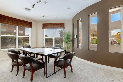 a dining room with a wooden table and chairs