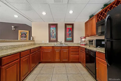 a large kitchen with stainless steel appliances granite countertop a stove sink and cabinets