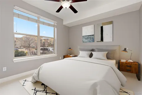 a bedroom with a large bed and a window