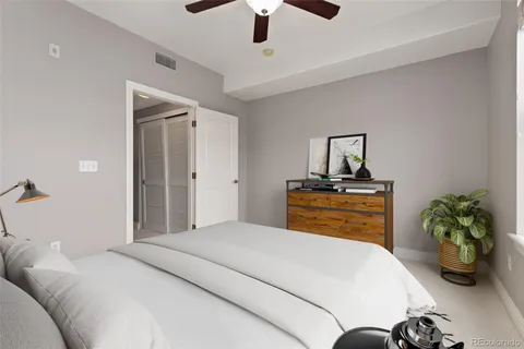 a bedroom with a bed and a potted plant