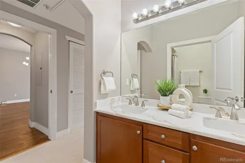 a bathroom with double vanity sinks a vanity and a mirror
