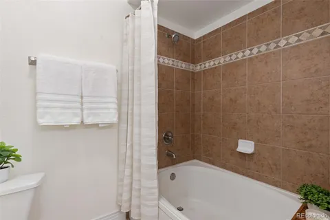 a bathroom with a white bath tub and a shower