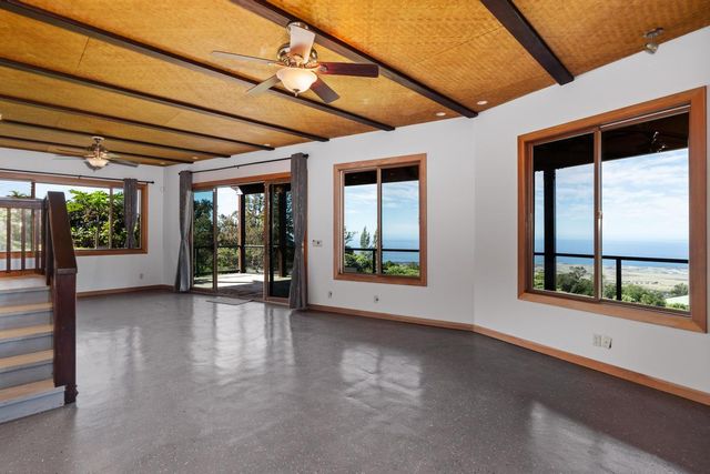 a view of a kitchen with wooden floor and a sink