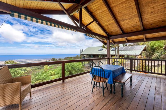 a bedroom with a bed and a couch next to a window