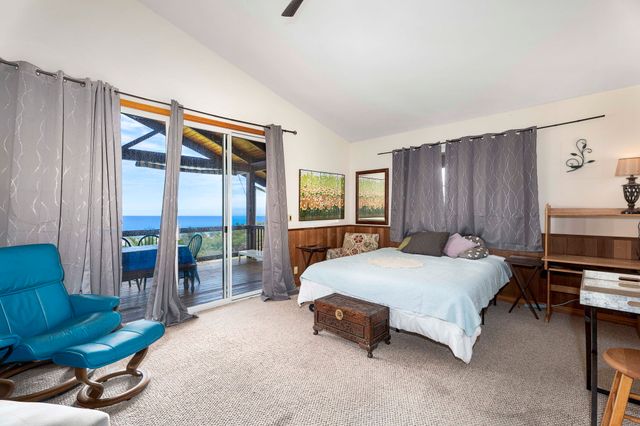 a bedroom with a bed and a potted plant