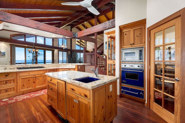 a kitchen that has a stove and a microwave oven