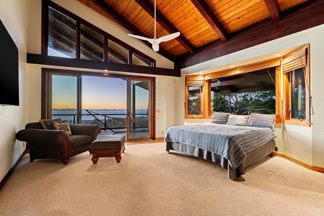 a spacious bedroom with a bed and glass door
