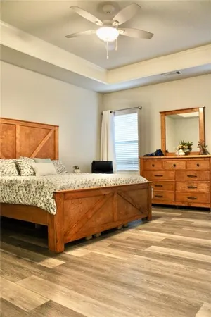 a living room with a bed and dresser