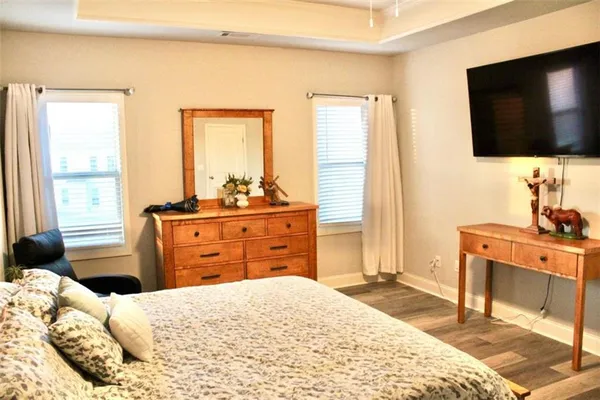 a bedroom with a bed and a flat screen tv